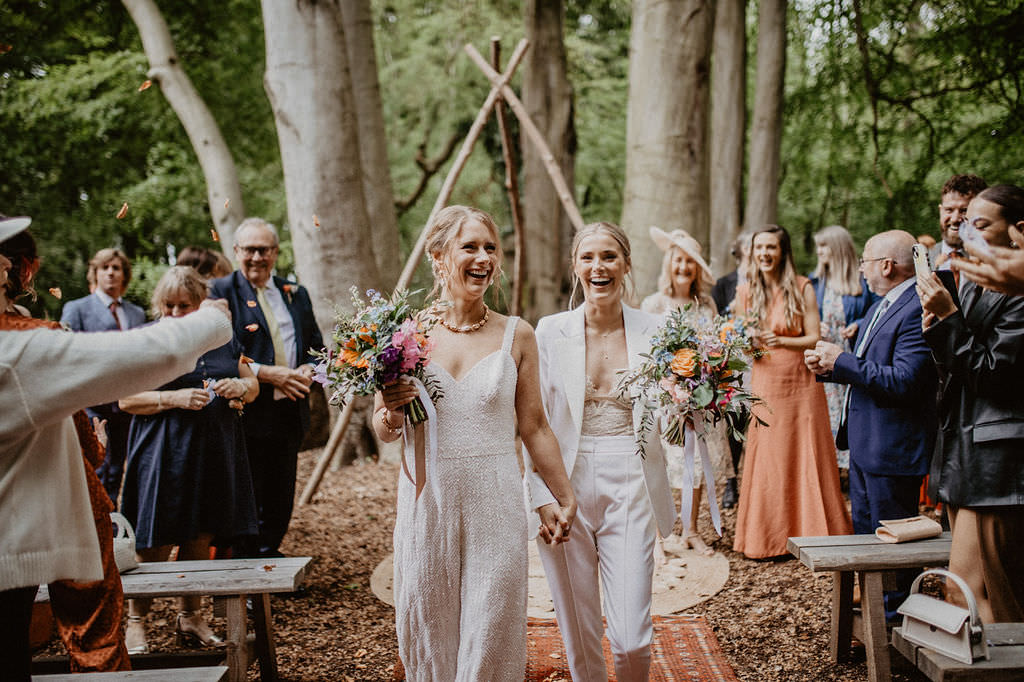 confetti throwing on couple in woodland wedding ceremony